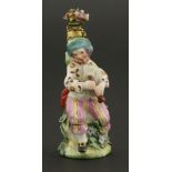 A Chelsea gold-mounted porcelain scent bottle,modelled as a musician playing a bagpipe, seated by