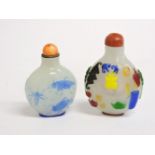 Two Chinese overlaid glass snuff bottles and stoppers, 6.5cm and 5.5cm high