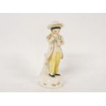 A Rockingham bone china figure of a boy, wearing a hat, in yellow breeches, 11.5cm high