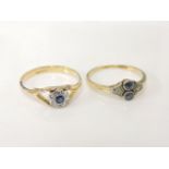 A gold Art Deco two stone sapphire ring, with diamond set shoulders marked 18ct, and an 18ct gold