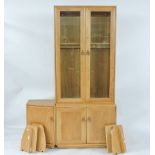 A modern Ercol light elm modular side cabinet, with glazed upper section, with cupboards beneath,