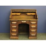 A late 19th/ early 20th century serpentine tambour front desk, by Shoolbred