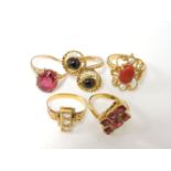 An Indian gold coral cabochon and split pearl ring, with decorative border marked 22-20ct gold,