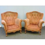 A pair of 19th century French armchairs, standing on carved cabriole legs