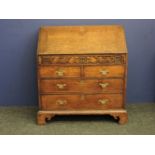 An 18th century oak bureau, possibly Welsh (top drawer with signs of old handles, movement splits to