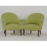 A pair of tub chairs, upholstered in green fabric, upon moulded scrolled front legs