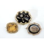 A rolled gold black enamel memorial brooch, set with a single rose cut diamond and split pearl