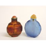 Two Chinese coloured glass snuff bottles and stoppers, with moulded elephant decoration, 6cm and 5.