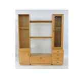 A modern Ercol light elm modular entertainment unit, low television stand flanked by glazed cupboard