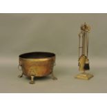 A brass oval coal bin, on lion paw feet, with mask and ring handles, a pair of 19th century cast