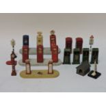 Dinky and other cold painted lead petrol pumps, oil pumps, two telephone boxes, traffic signals