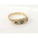 A gold boat shaped sapphire and diamond ring