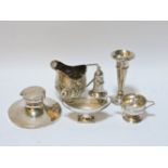 A silver pepperette, a small silver cream jug, a capstan inkwell, a silver bud vase, etc