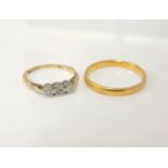 A gold three stone illusion set ring, marked plat and 18ct, 3.4g, and a 22ct gold D shaped wedding