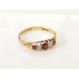 An 18ct gold boat shaped graduating five stone ruby and diamond ring