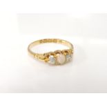 An 18ct gold opal and diamond three stone ring