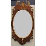 A George III mahogany fret carved mirror, with oval plate and inlaid shell motif, 97cm