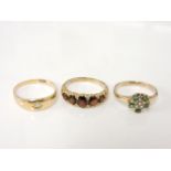 A 9ct gold graduating five stone oval cut garnet ring, a gold seed pearl and green paste cluster