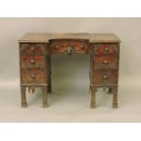 A 19th century and later neo classical break front knee hole desk, leather inset top and seven