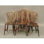 A matched set of six wheel back dining chairs