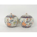 A pair of Chinese vases and covers, 19cm high