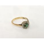 An 18ct gold green tourmaline and diamond cluster ring