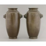 A pair of Shisou bronze vases, 19th century, the ovoid bodies with twin lion mask handles in 17th