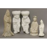 A pair of 19th century white-glazed wall pockets, each modelled as a boy with pipe and bottle, a
