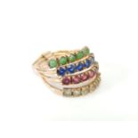 A gold four row hareme ring, set with synthetic green, blue, red and white stones, tested as 14ct