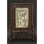 An early 20th century, rectangular jade panel, pierced and carved in Ming style with a flowering
