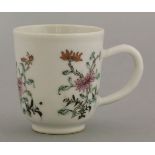 A unusual mid 19th century famille rose coffee cup, with three groups of flowers including lily,