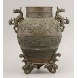 A fine bronze vase, c.1870, the ovoid body cast with mythical beast lappets above a band of
