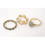 A gold diamond cluster ring, tested as 18ct gold, one stone deficient and marks rubbed, a 9ct gold