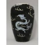 A late 19th century mirror black vase, enamelled with dragons amongst clouds, six character mark