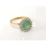 A gold circular emerald and diamond cluster ring, marked 18ct, 4.41g