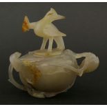 An unusual 20th century agate bowl and cover, the dove-grey body with a slight purple tinge carved