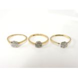 Three 18ct gold diamond daisy cluster rings, two damaged