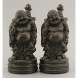 A pair of 20th century carved hardwood Budai, each smiling with his sack of gold on the back and a