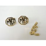 A pair of 9ct gold MG emblem cufflinks, and a single stone diamond pound sign pendant