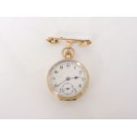 A 9ct gold ladies fob watch, with white enamel dial and secondary seconds dial, with engraved