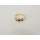 A gold five stone sapphire and diamond ring, tested as approximately 18ct gold, later half shank