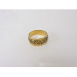 A gold gentlemen's tapering band ring, with applied zodiac symbols, tested as approximately 18ct