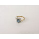 A 9ct gold blue topaz and diamond cluster ring, size P, 2.75g