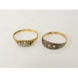 An 18ct gold five stone diamond ring, one stone deficient, and a three stone ring, two stones
