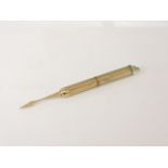 A 9ct gold engine turned decorated self propelling toothpick, by SJ Rose, 5.6g