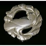 A sterling silver brooch,by Georg Jensen, No.123, a dove within a foliate wreath with a plain pin