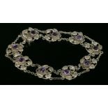 A sterling silver Arts and Crafts amethyst bracelet,with a series of wire heart-shaped plaques, each