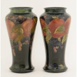 Two Moorcroft ‘Pomengranate’ vases,of baluster form, one with trailing leaves to the lower edge,
