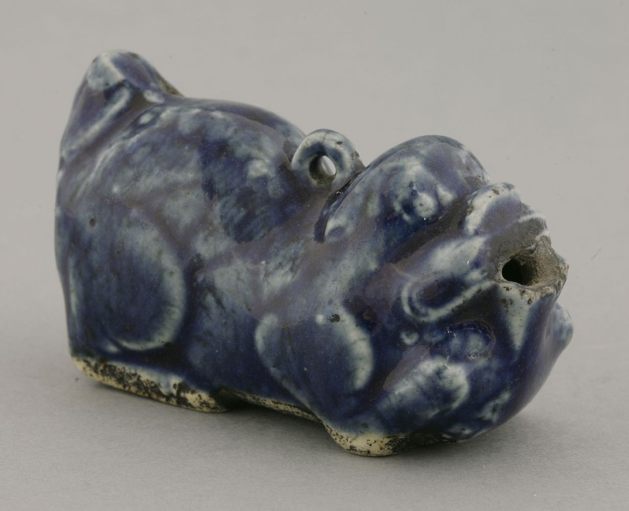 A porcelain blue glaze Water Dropper,18th century, in the form of a reclining Buddhist lion, the - Image 2 of 3