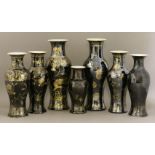 Seven baluster vases, late 19th century, mirror black with gilt decoration, two with six character